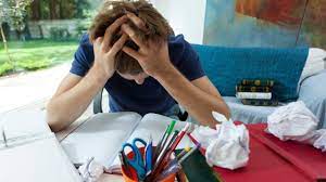 Image: A person surrounded by scattered papers and digital devices, reflecting the challenges of organizing personal and academic tasks. Illustrates the need for effective task management.